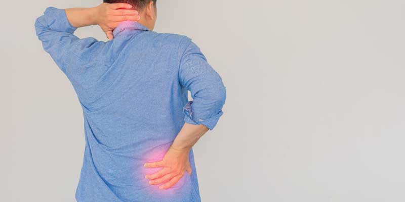 A male patient holding their neck and back with radiating pain that appears as glowing red.